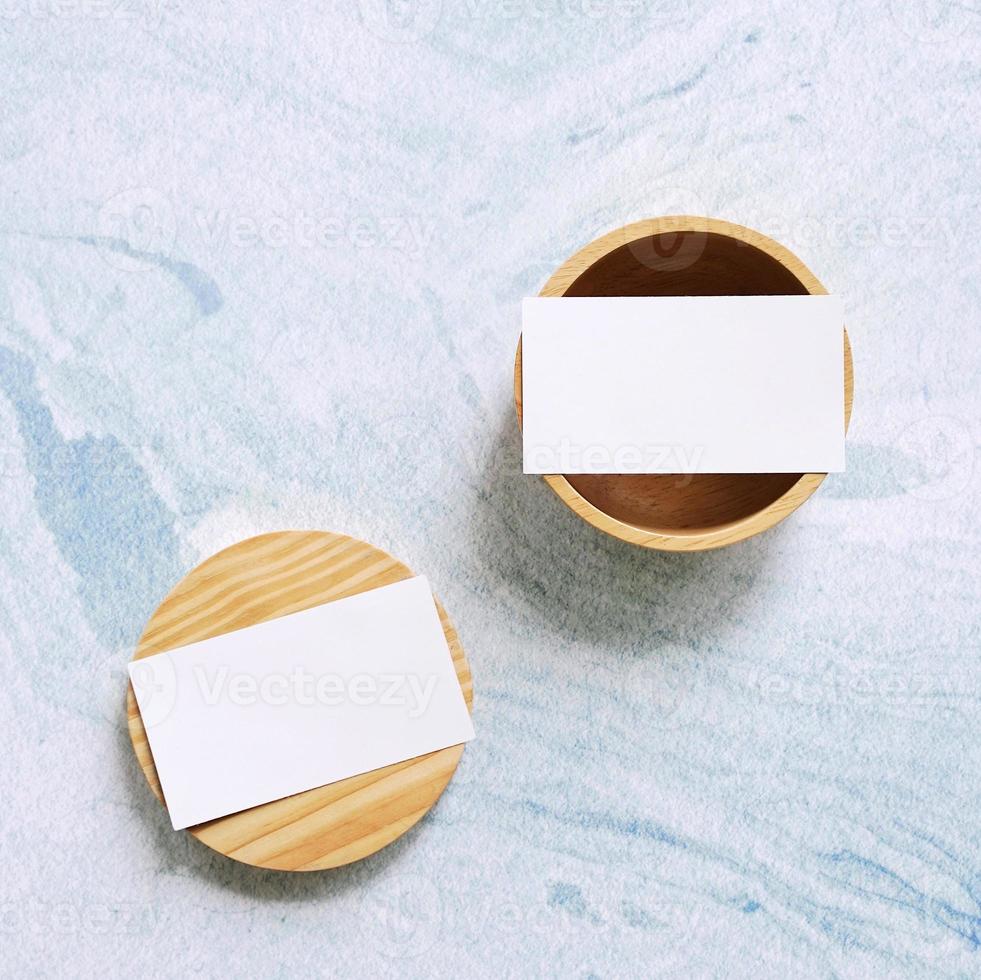 Flat lay branding identity business name card on wooden container with blue marble background, minimal concept for design photo