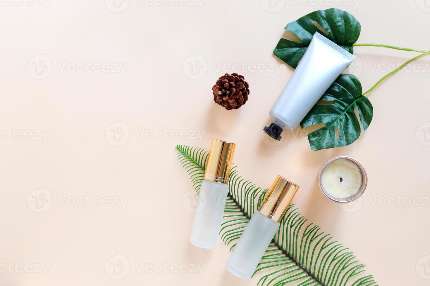 Flat lay of various organic skincare and beauty products for mock up with green leaves in minimal style photo