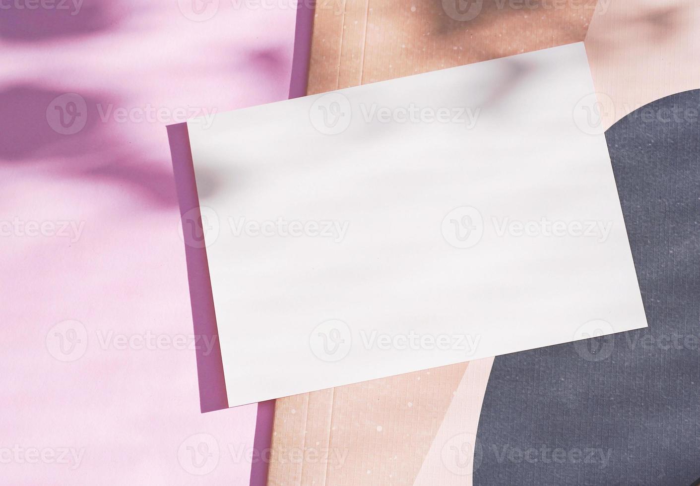 Flat lay of branding identity blank postcard on pink background with light and shadow from leaves botany, minimal concept for design photo