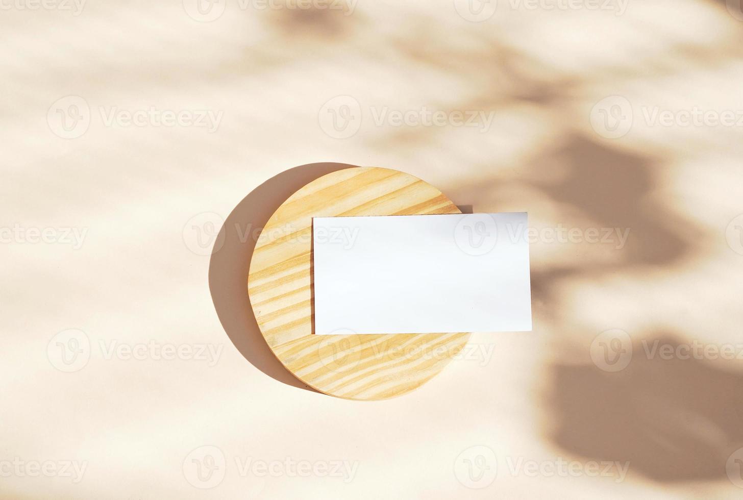 Flat lay of branding identity business name card on wooden and yellow background, light and shadow shape leaves, minimal concept for design photo