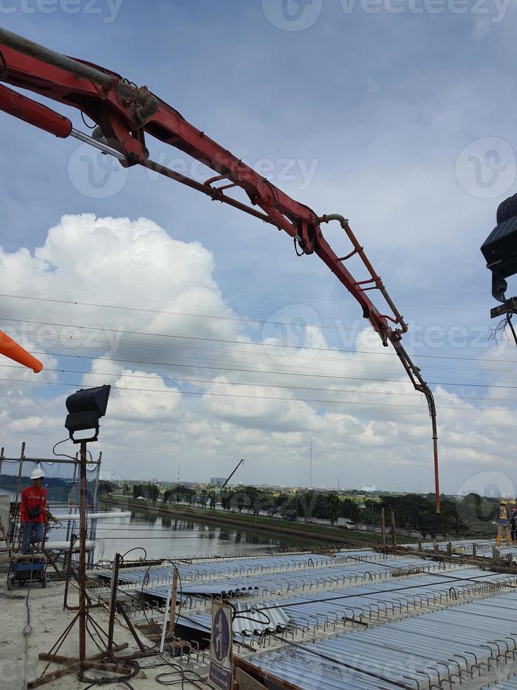 This is a process of casting concrete using a concrete pump to reach casting locations that are far away. photo