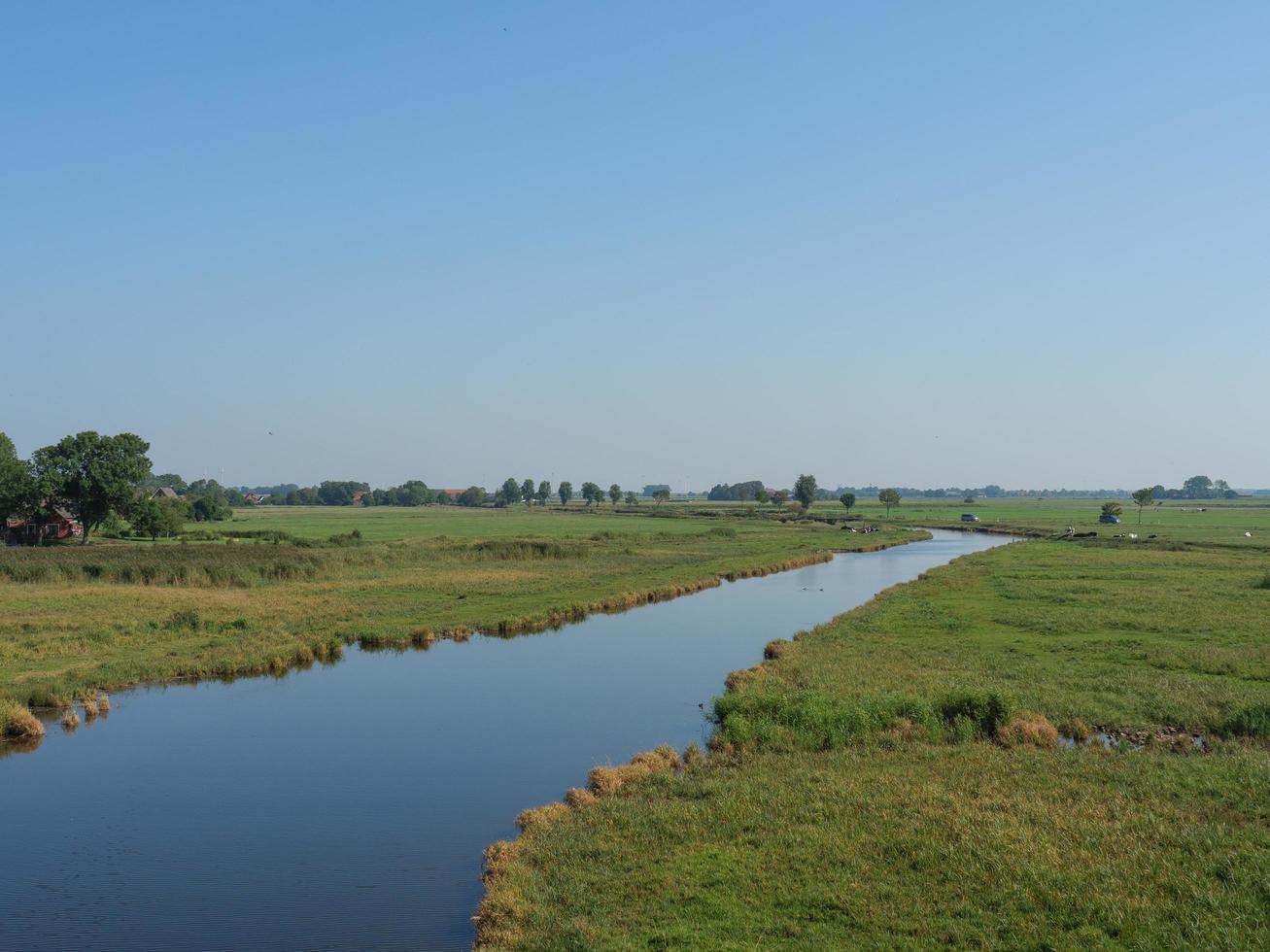 ditzum,germany,2020-the small village of ditzum at the river ems in germany photo