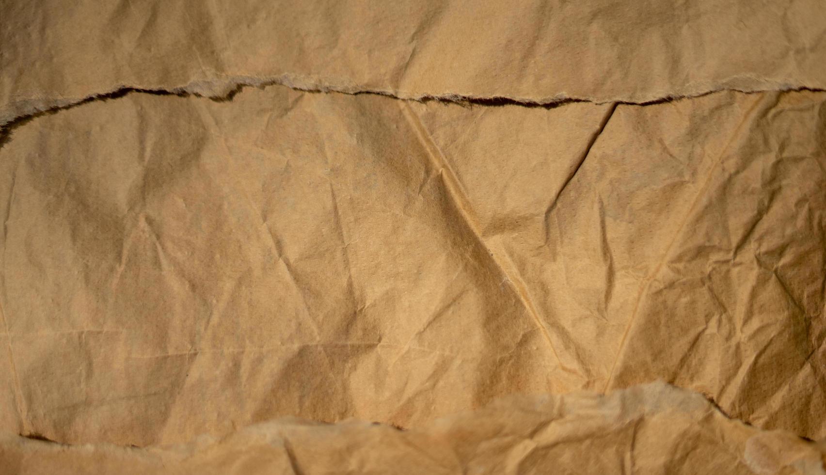 golden old paper with torn and crumpled texture for background photo