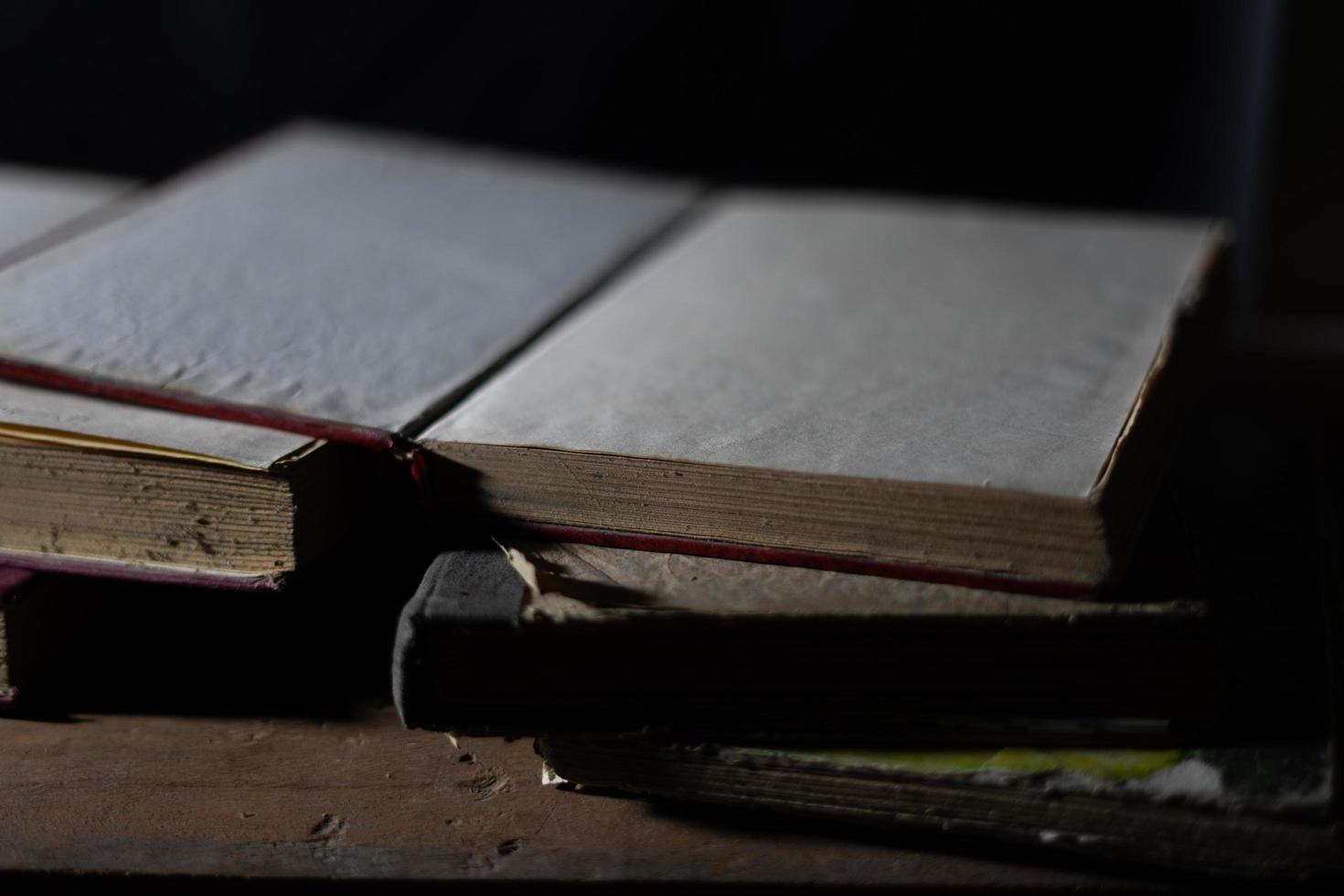 a collection of old books that are weathered in piles. vintage and retro theme backgrounds photo