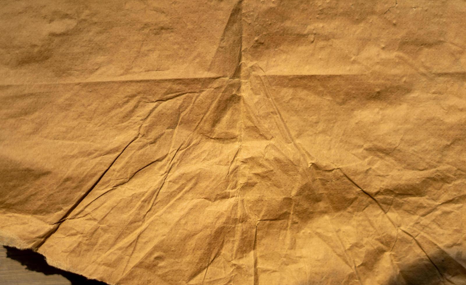 golden old paper with torn and crumpled texture for background photo