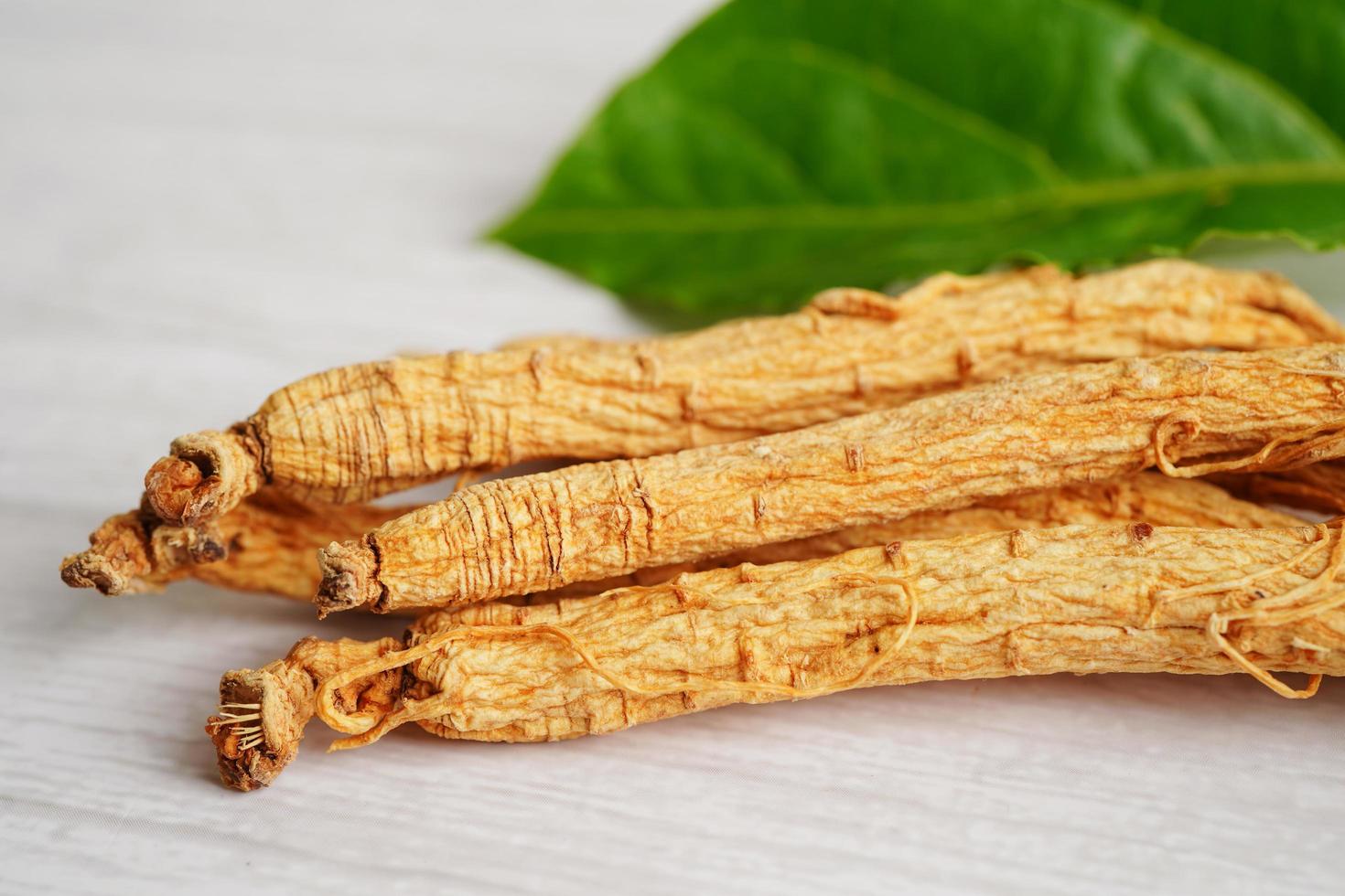 Ginseng roots and green leaf, healthy food. photo