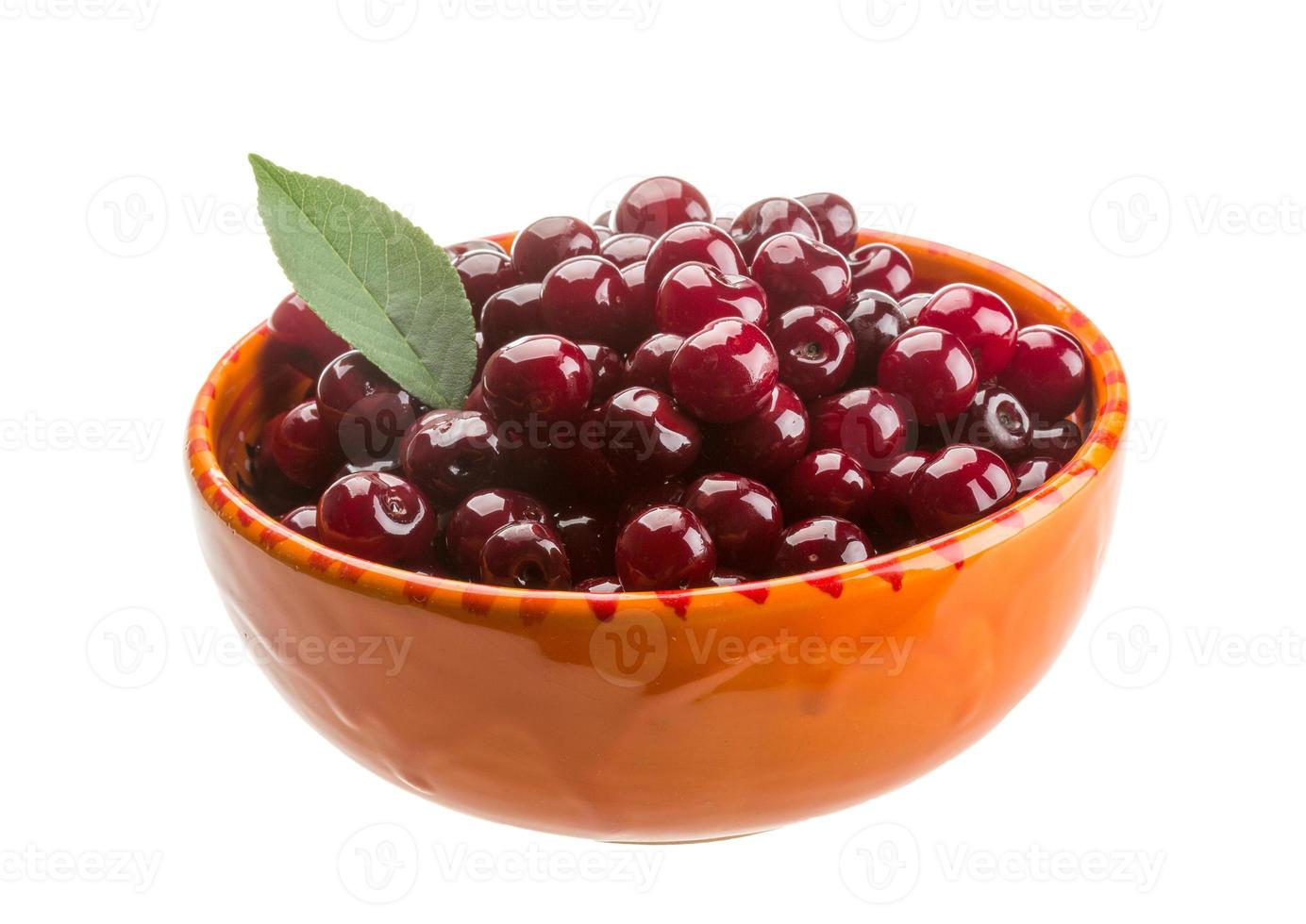 Cherry in the bowl on white background photo