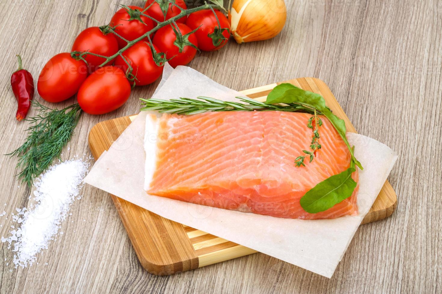 Salted salmon on wooden board and wooden background photo