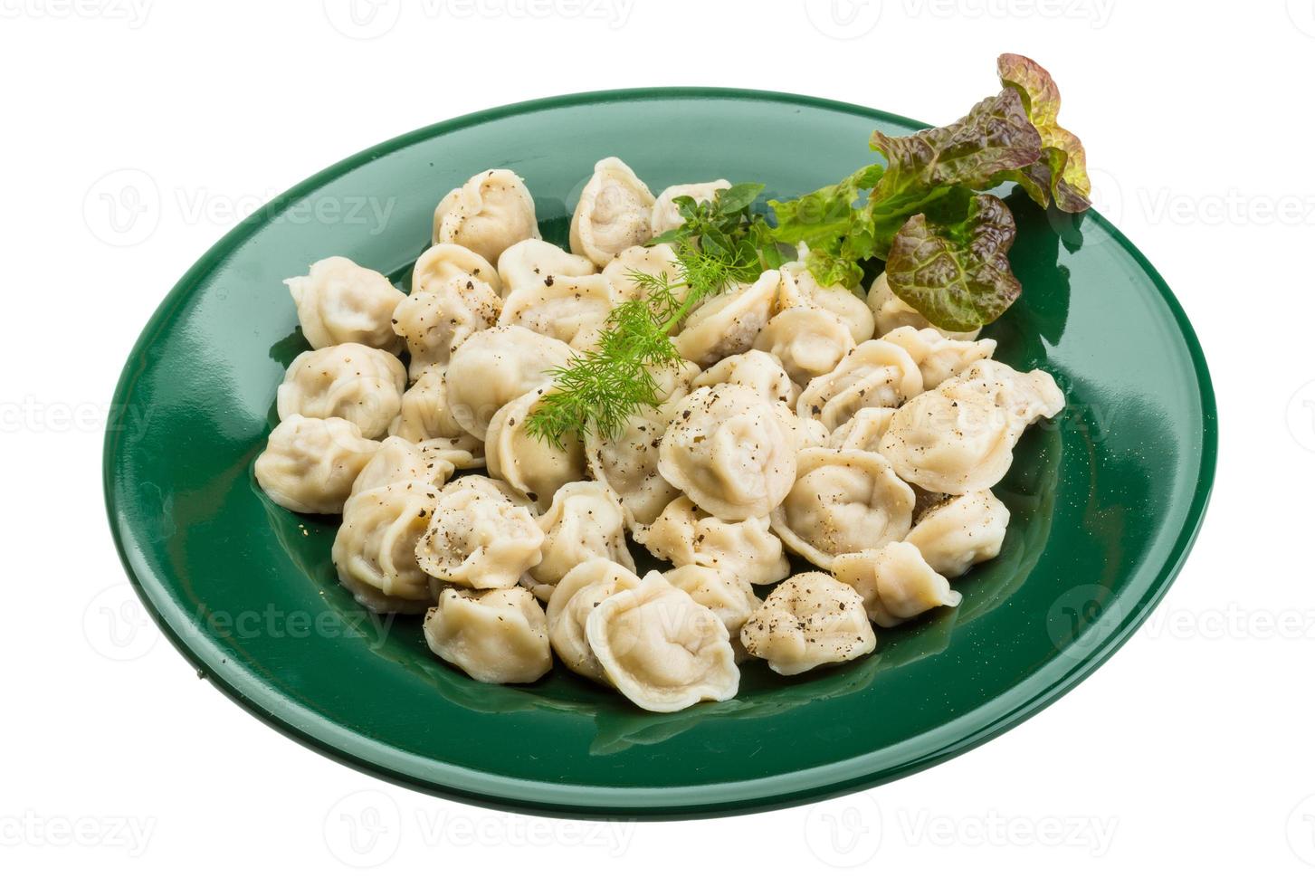 Russian dumplings on the plate and white background photo