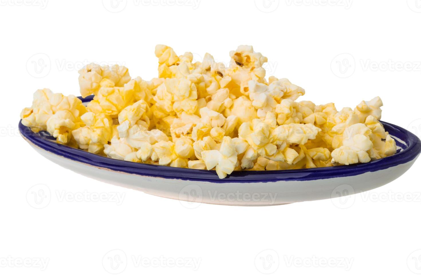 Popcorn in a bowl on white background photo