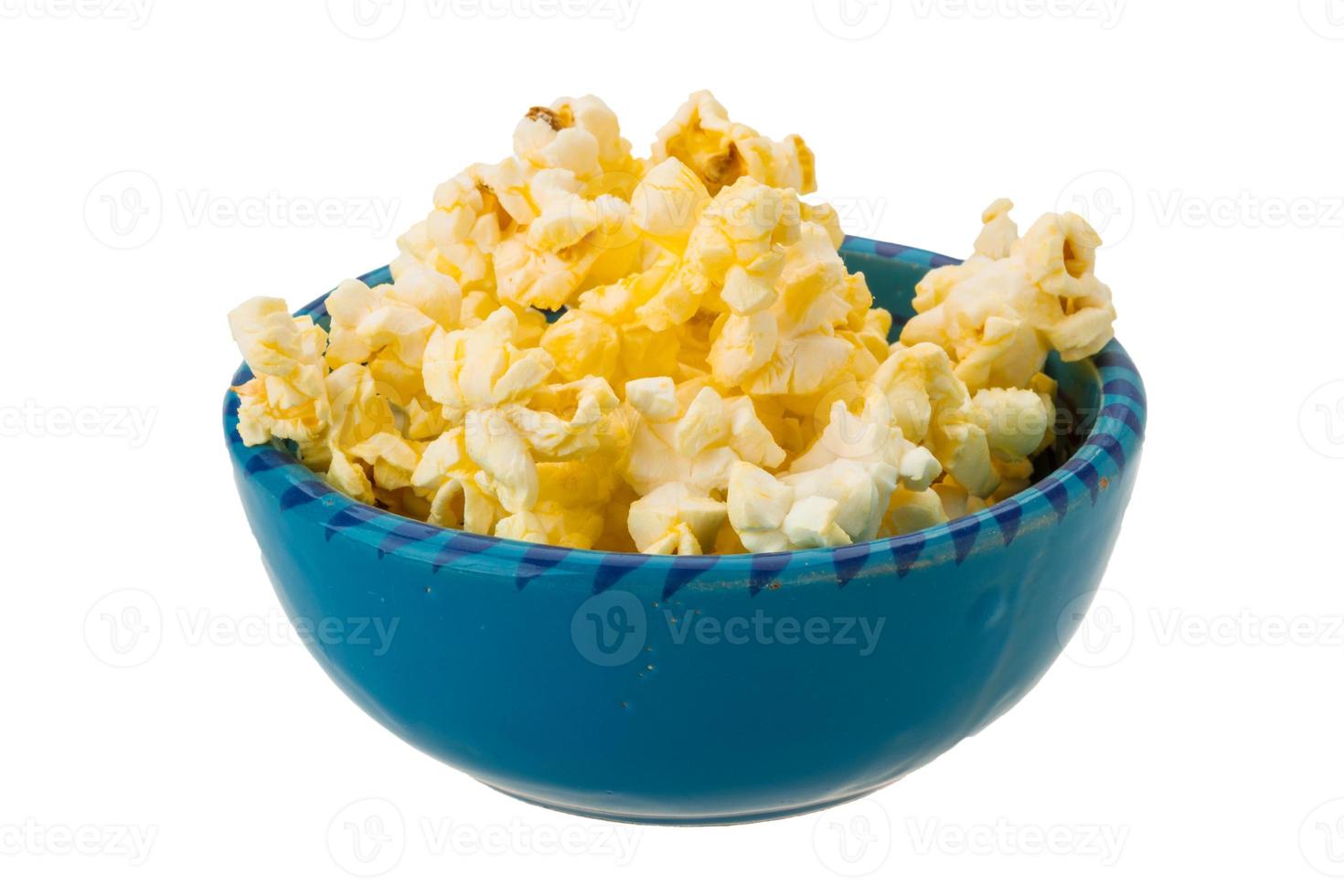 Popcorn in a bowl on white background photo