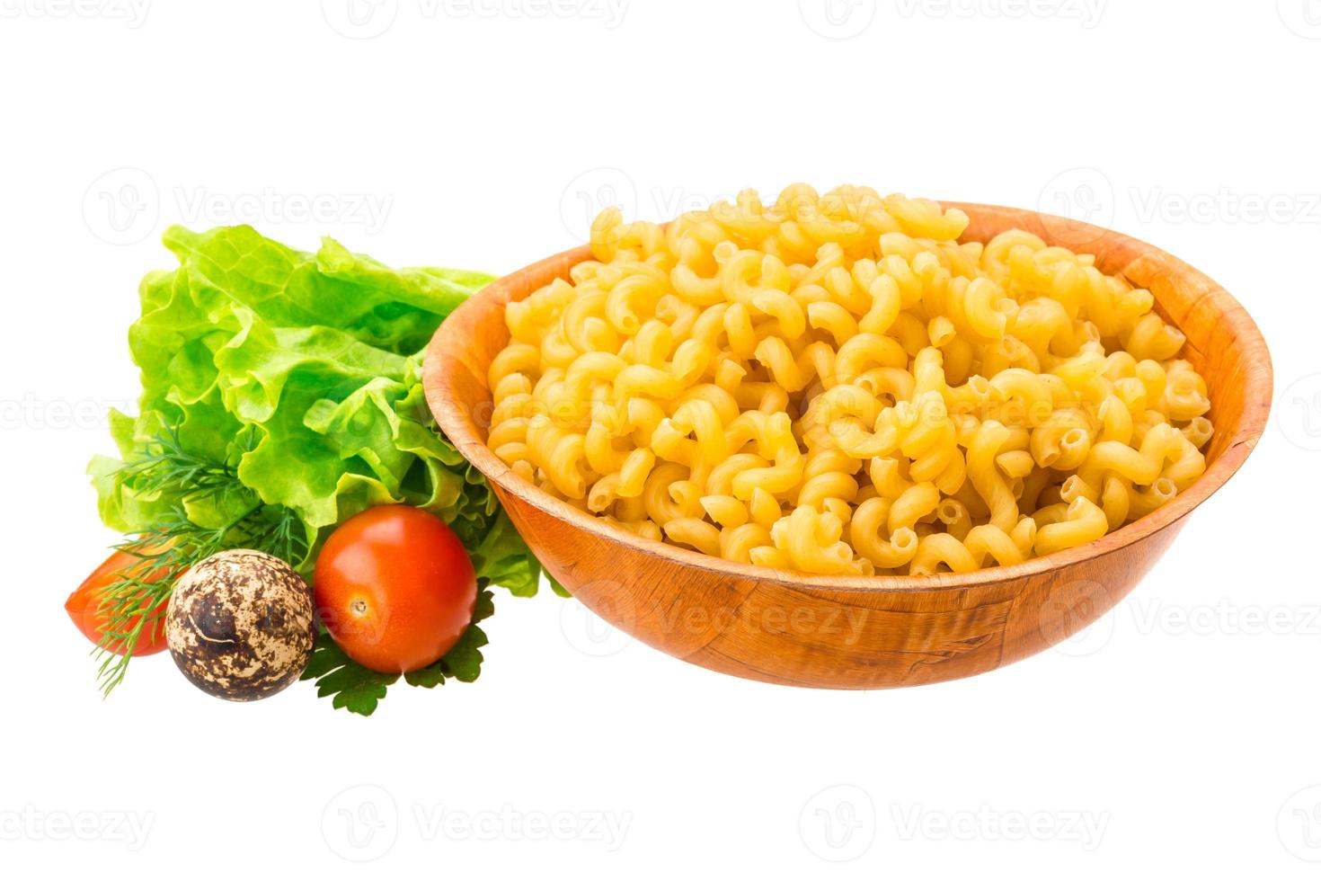 Fusilli pasta in a bowl on white background photo