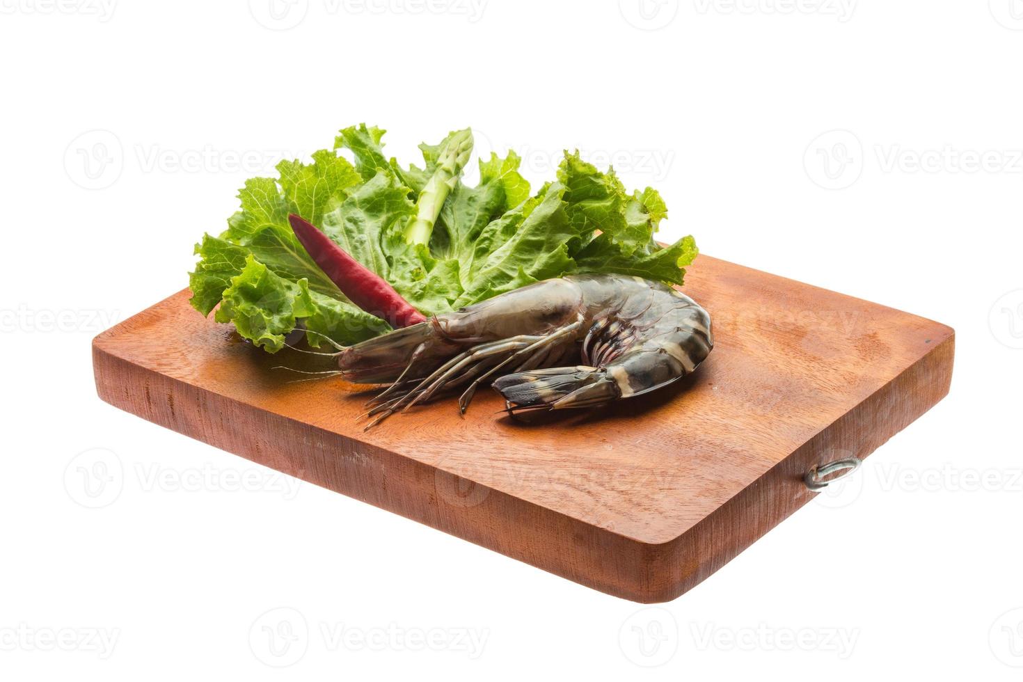 Tiger prawn on wooden board and white background photo