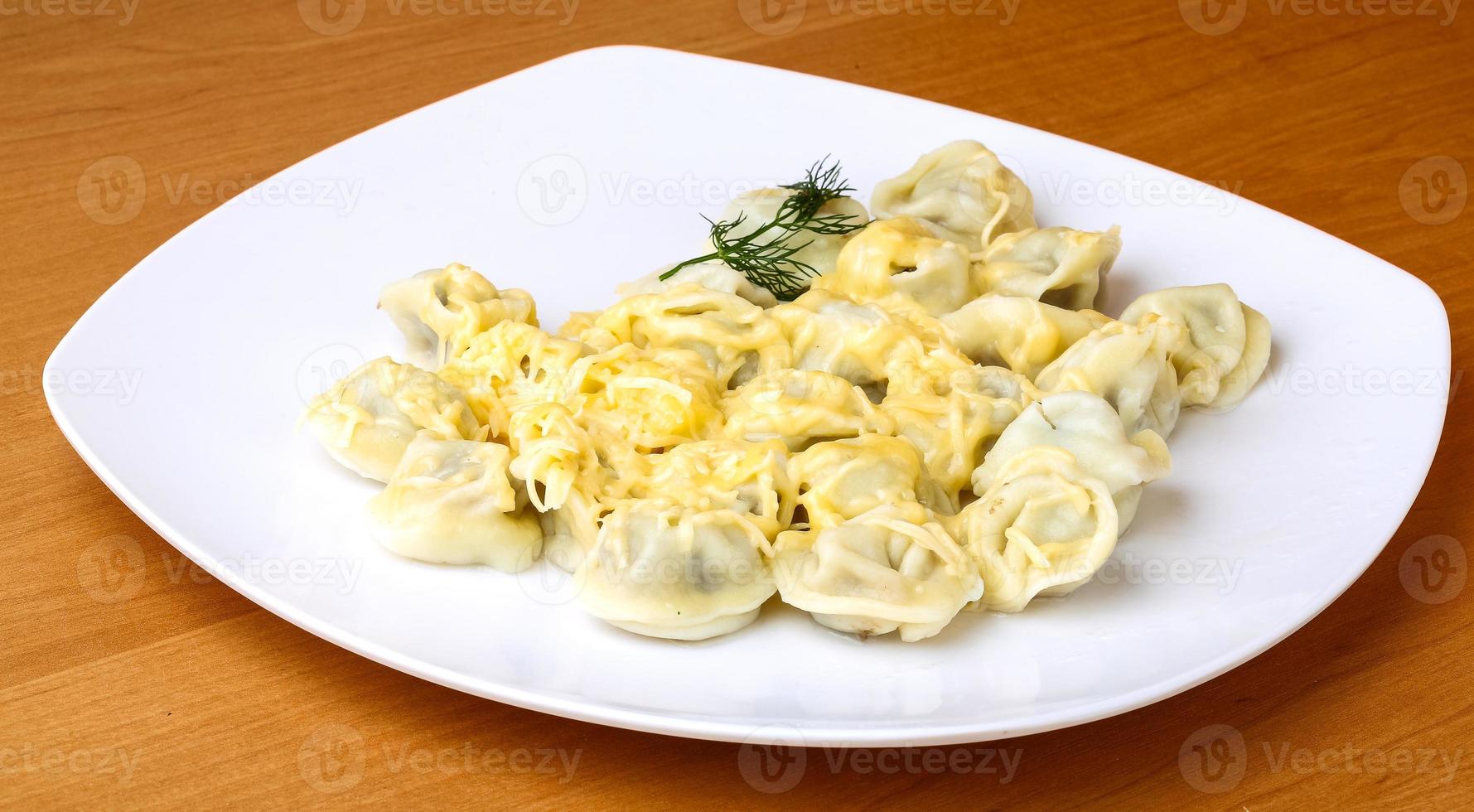 Russian dumplings on the plate and wooden background photo