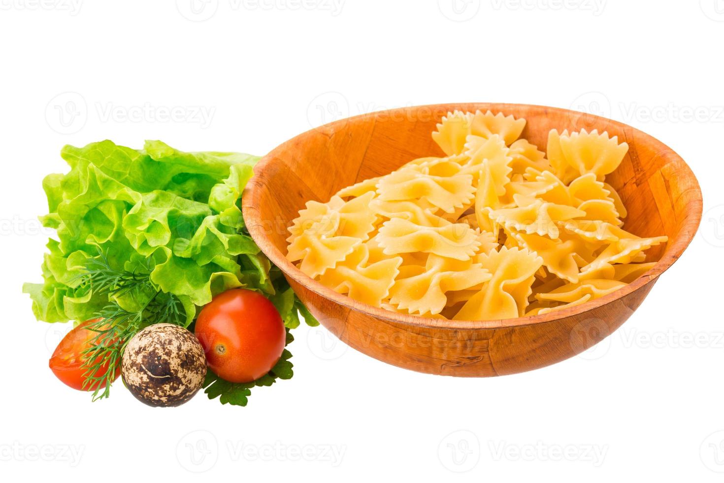 Raw pasta in a bowl on white background photo