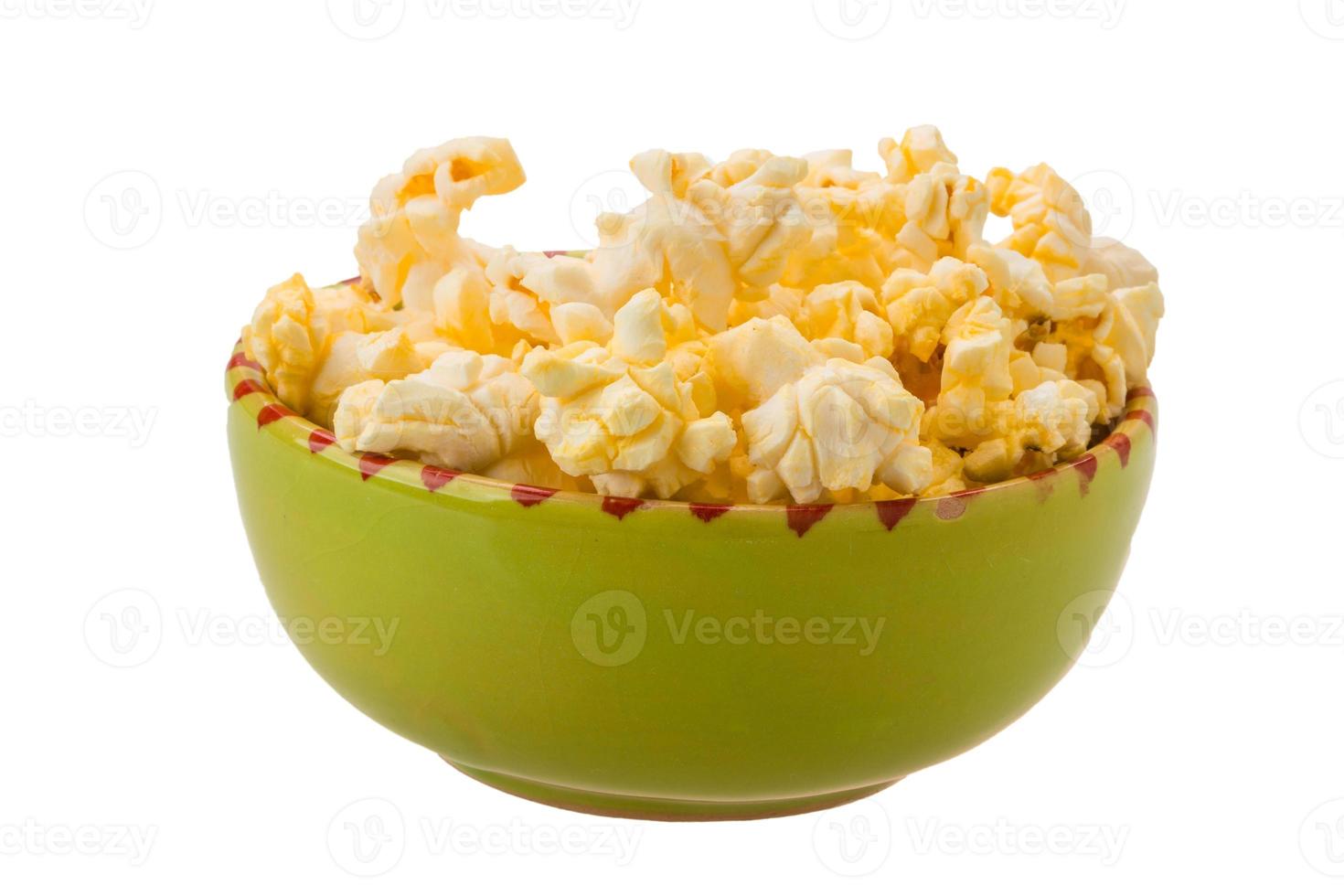 Popcorn in a bowl on white background photo