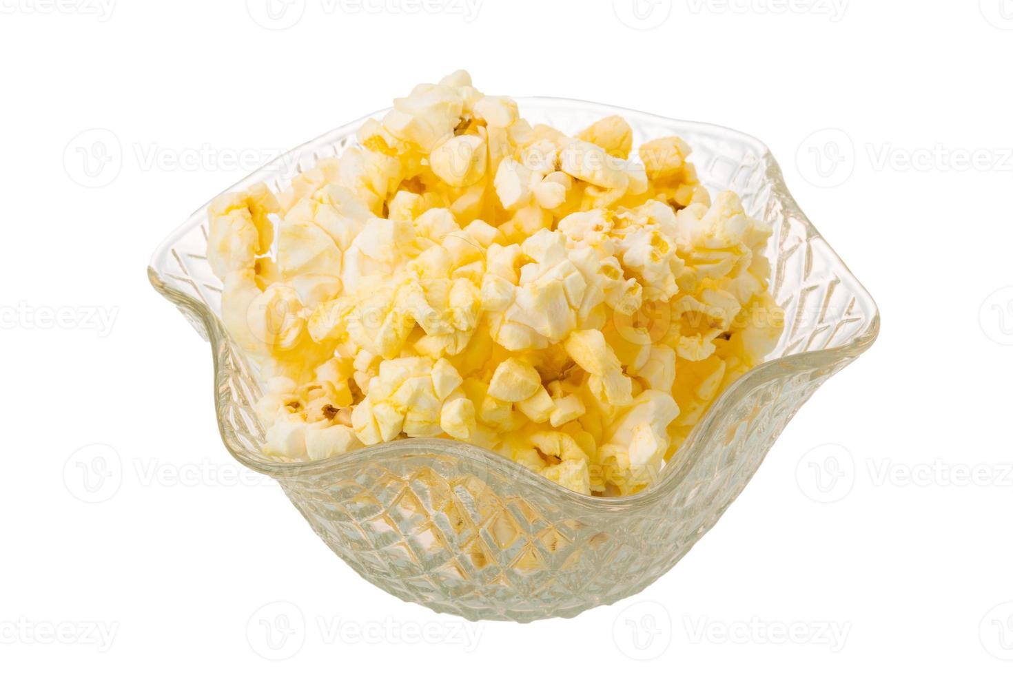 Popcorn in a bowl on white background photo