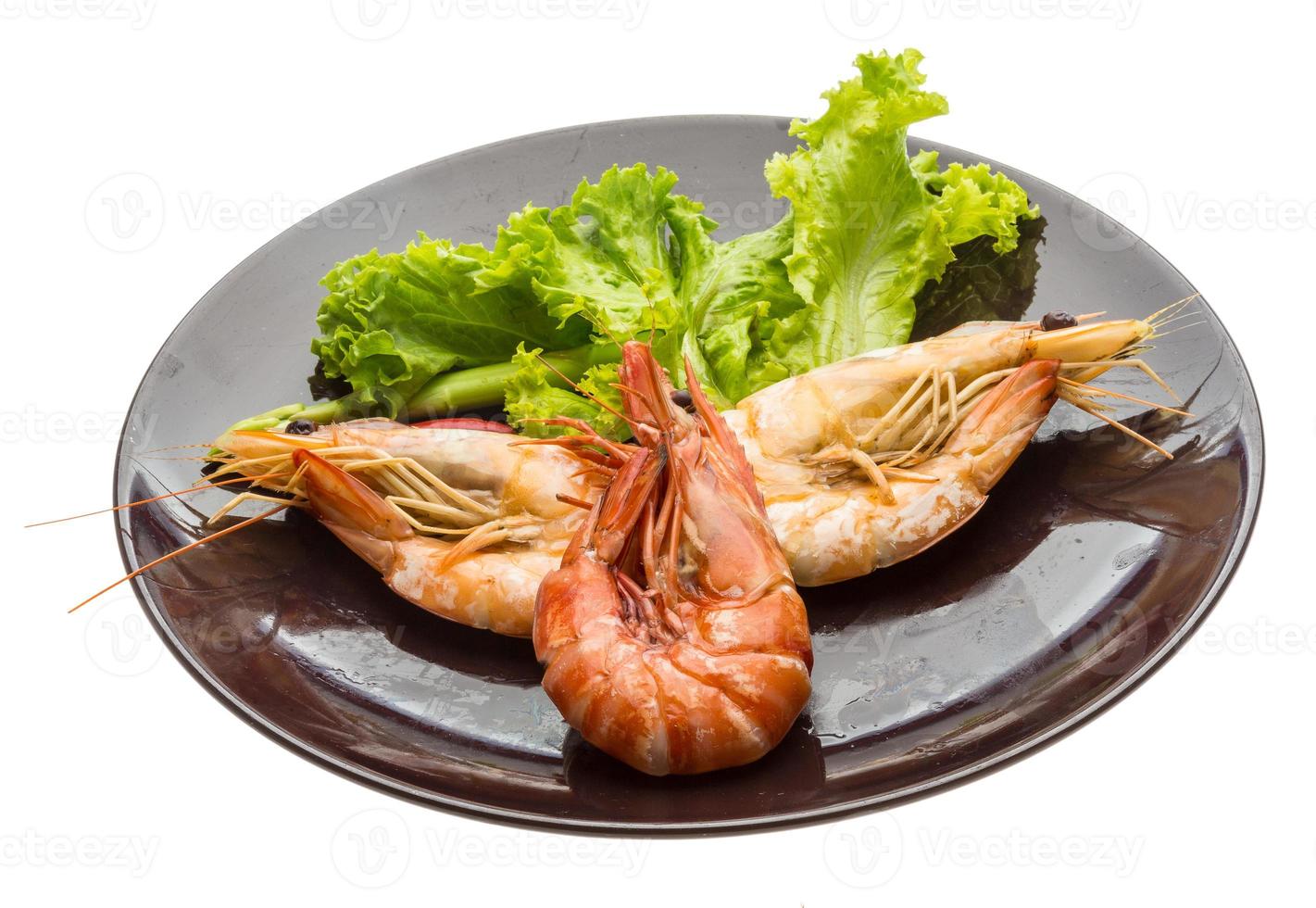 Boiled king prawns on the plate and white background photo