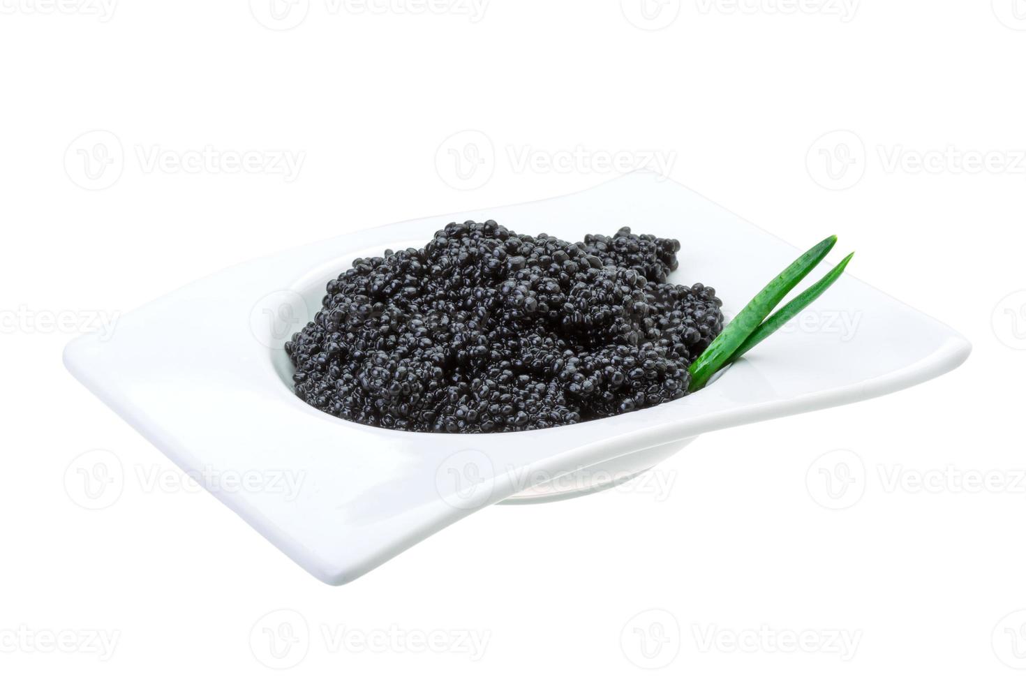 Black caviar in a bowl on white background photo