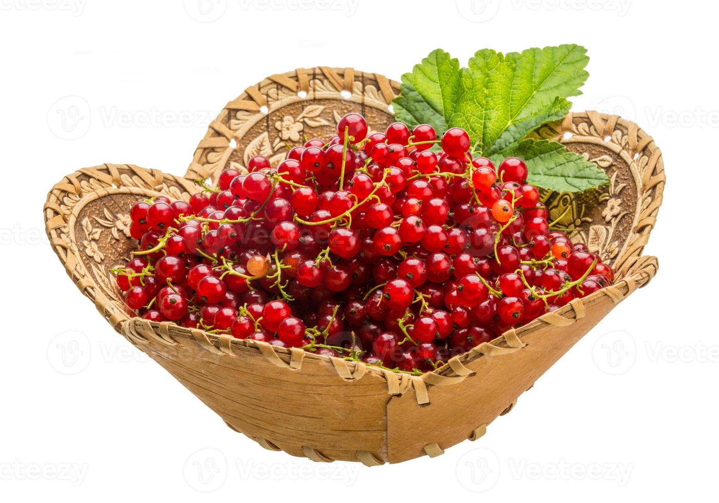 Red currant in a basket on white background photo
