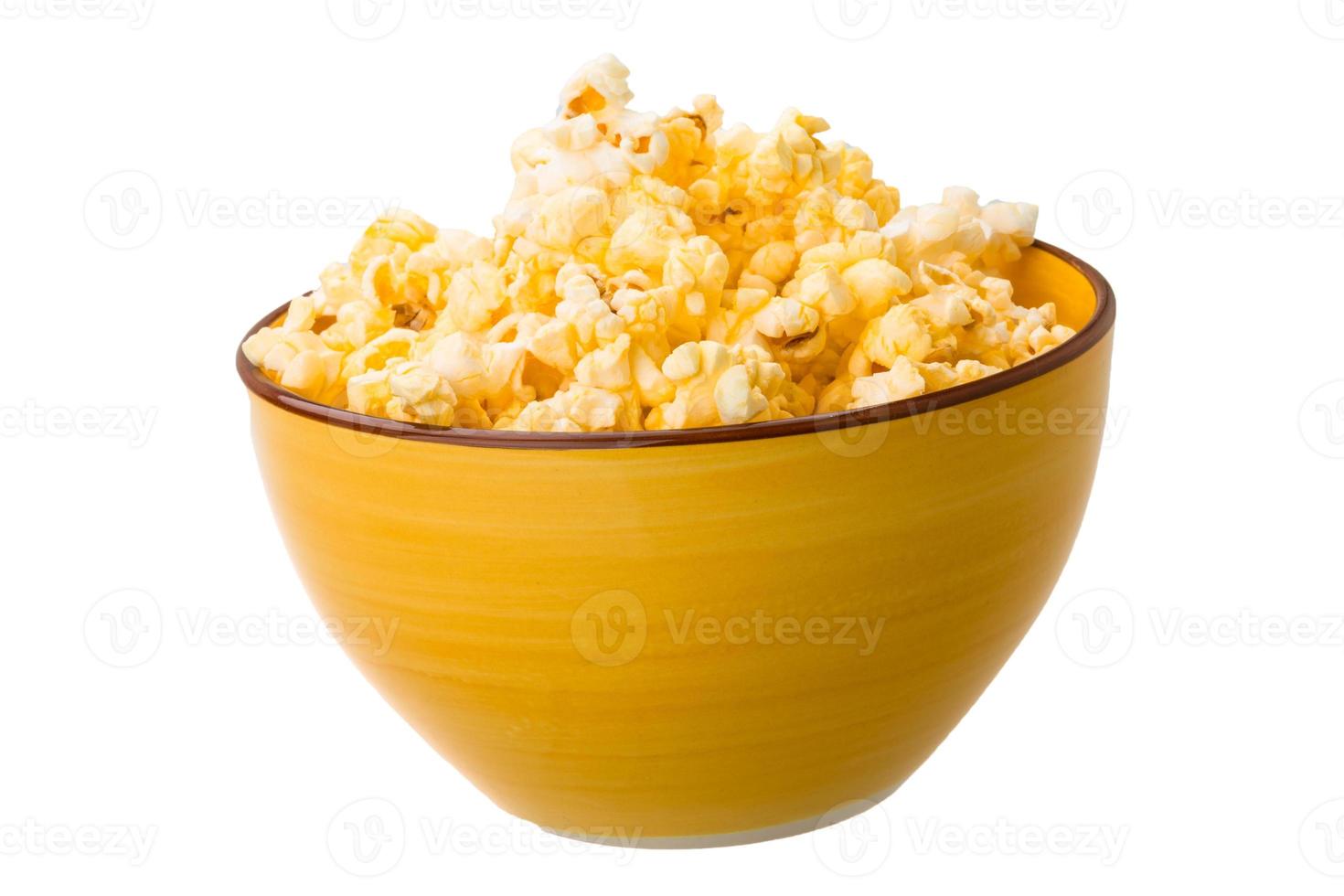 Popcorn in a bowl on white background photo