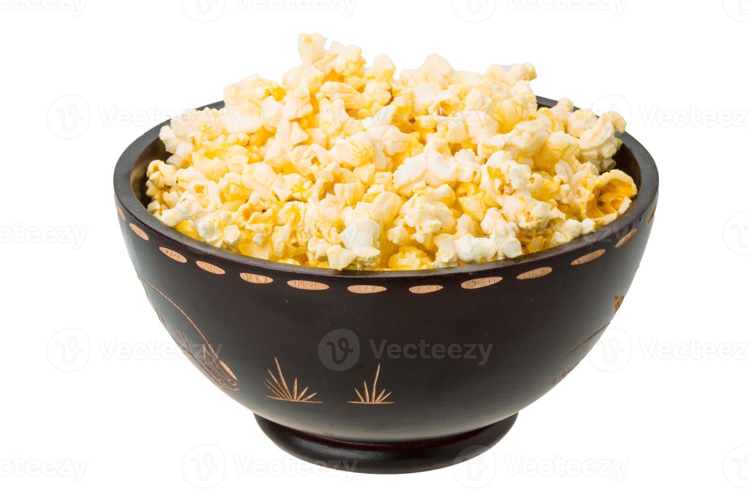 Popcorn in a bowl on white background photo