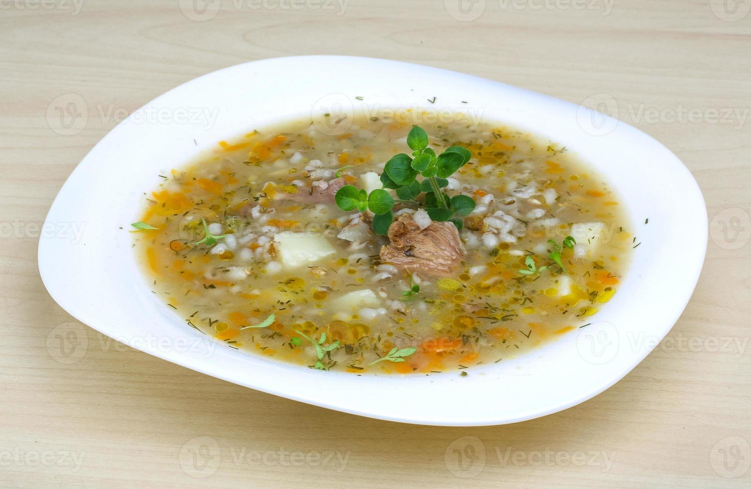 Cereal soup on the plate and wooden background photo