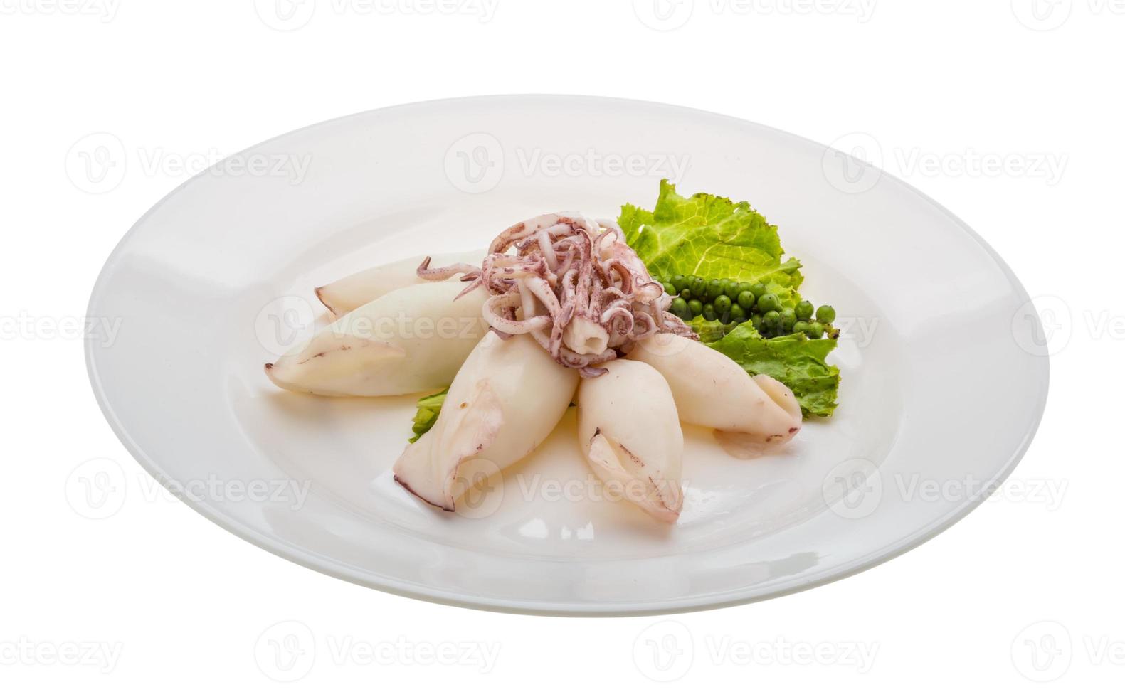 Boiled squid on the plate and white background photo