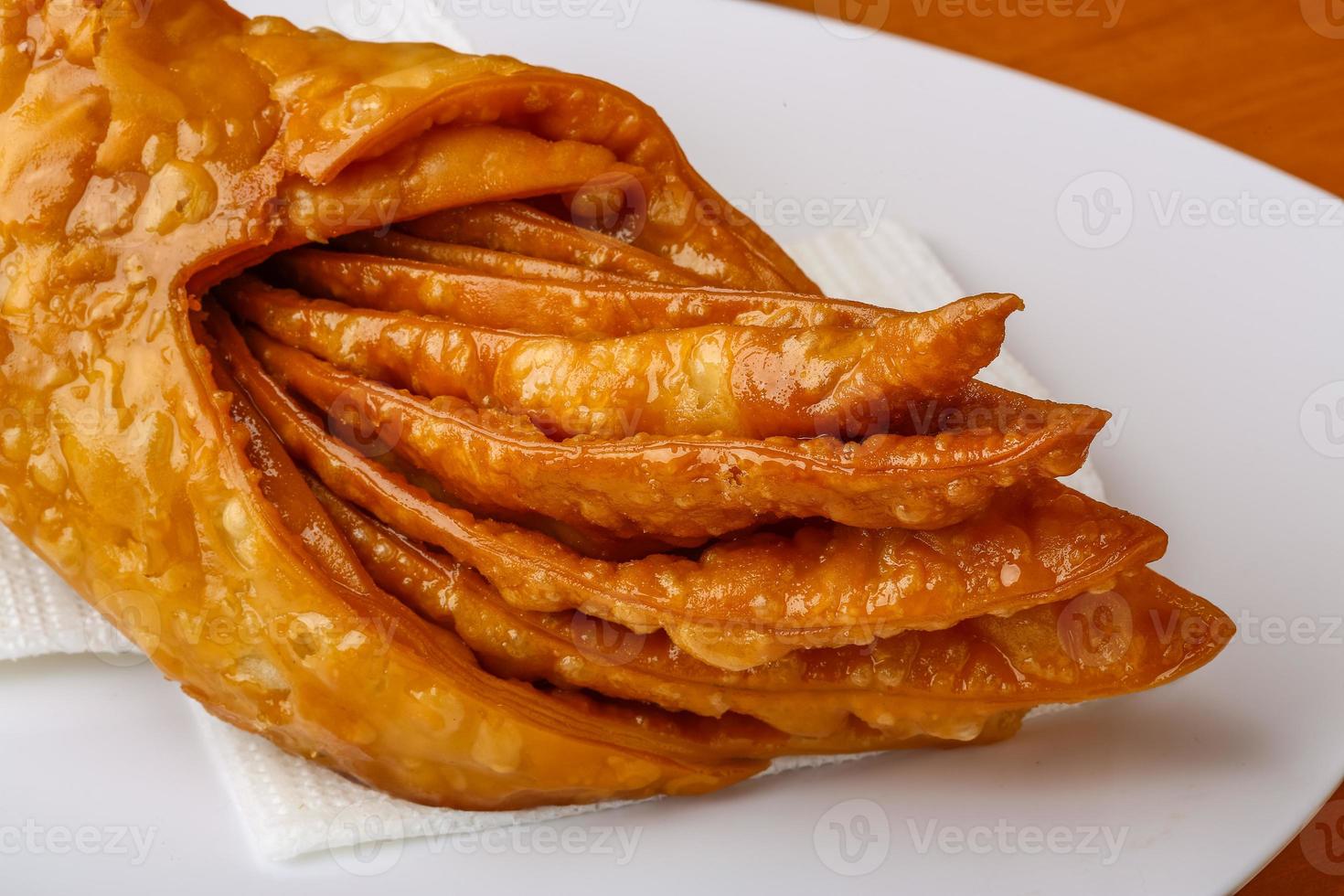 Baklava on the plate and wooden background photo