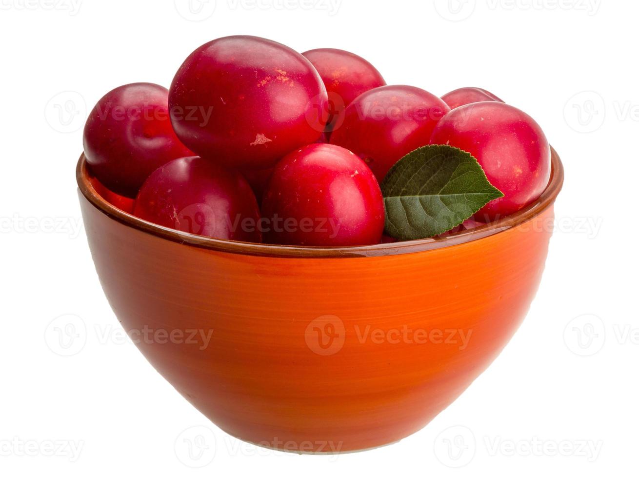 Damson plum in a bowl on white background photo