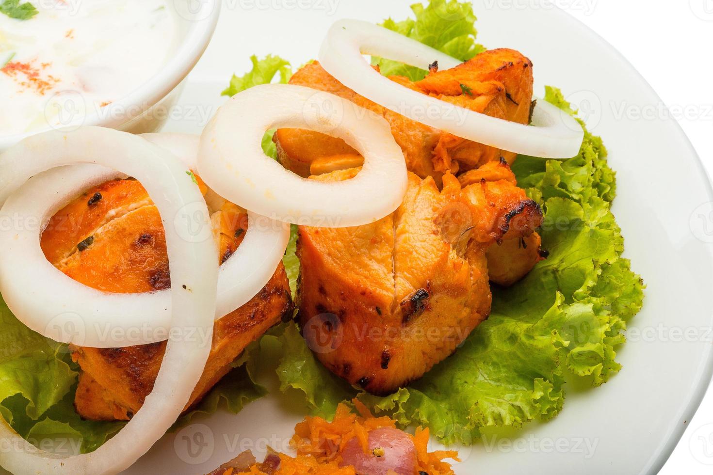 Chicken Tikka on the plate and white background photo