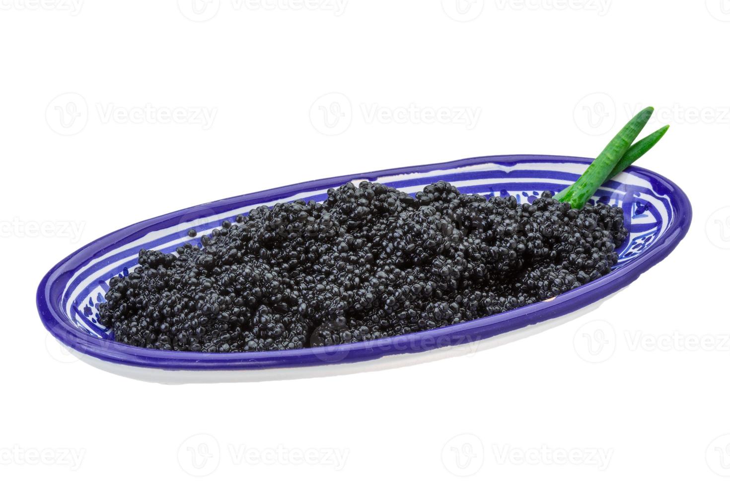 Black caviar in a bowl on white background photo