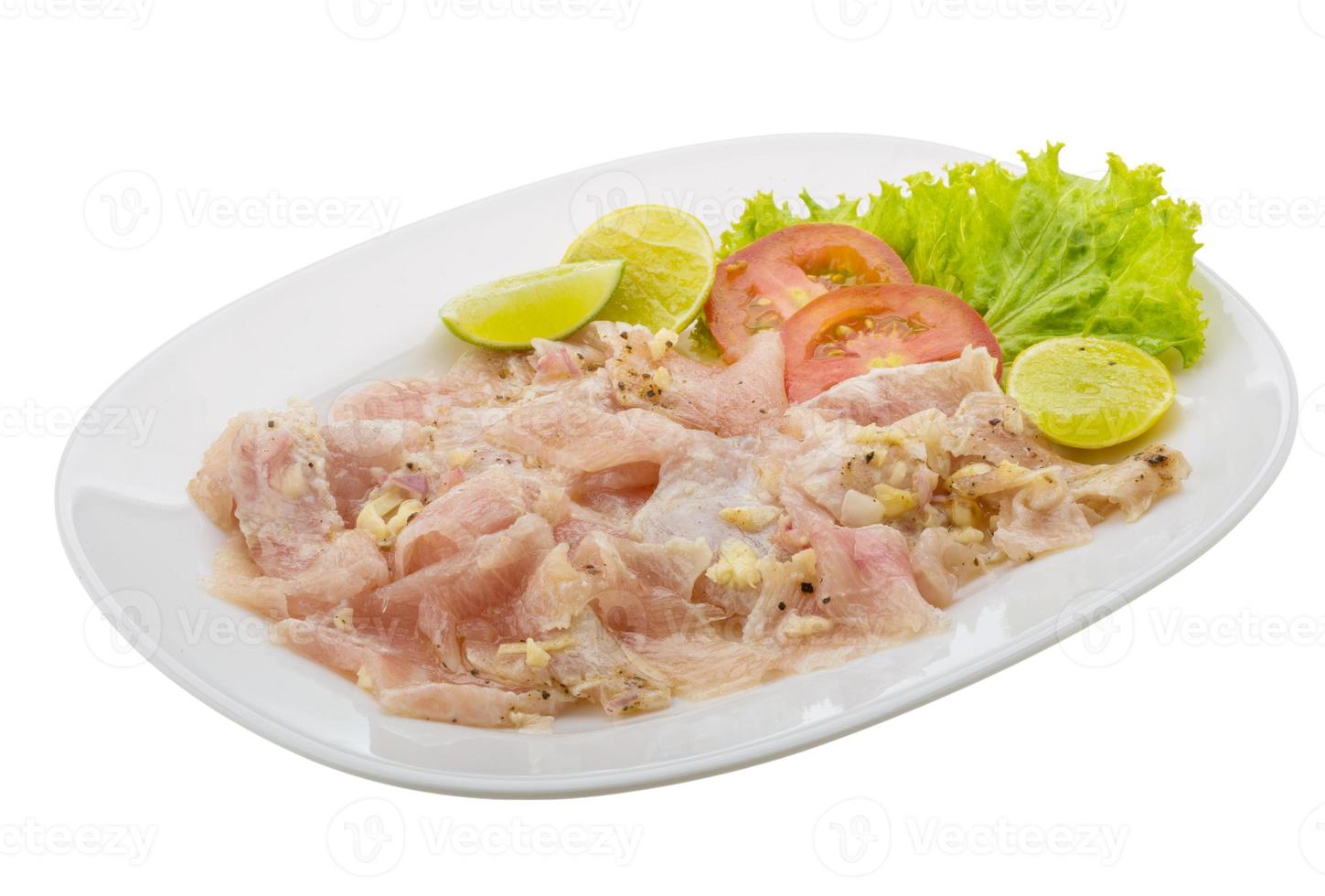 Swordfish carpaccio on the plate and white background photo