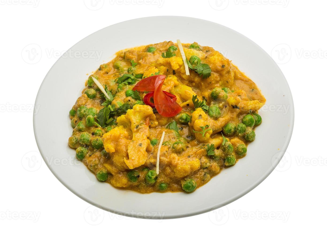 Gobi Mutter Kaju on the plate and white background photo
