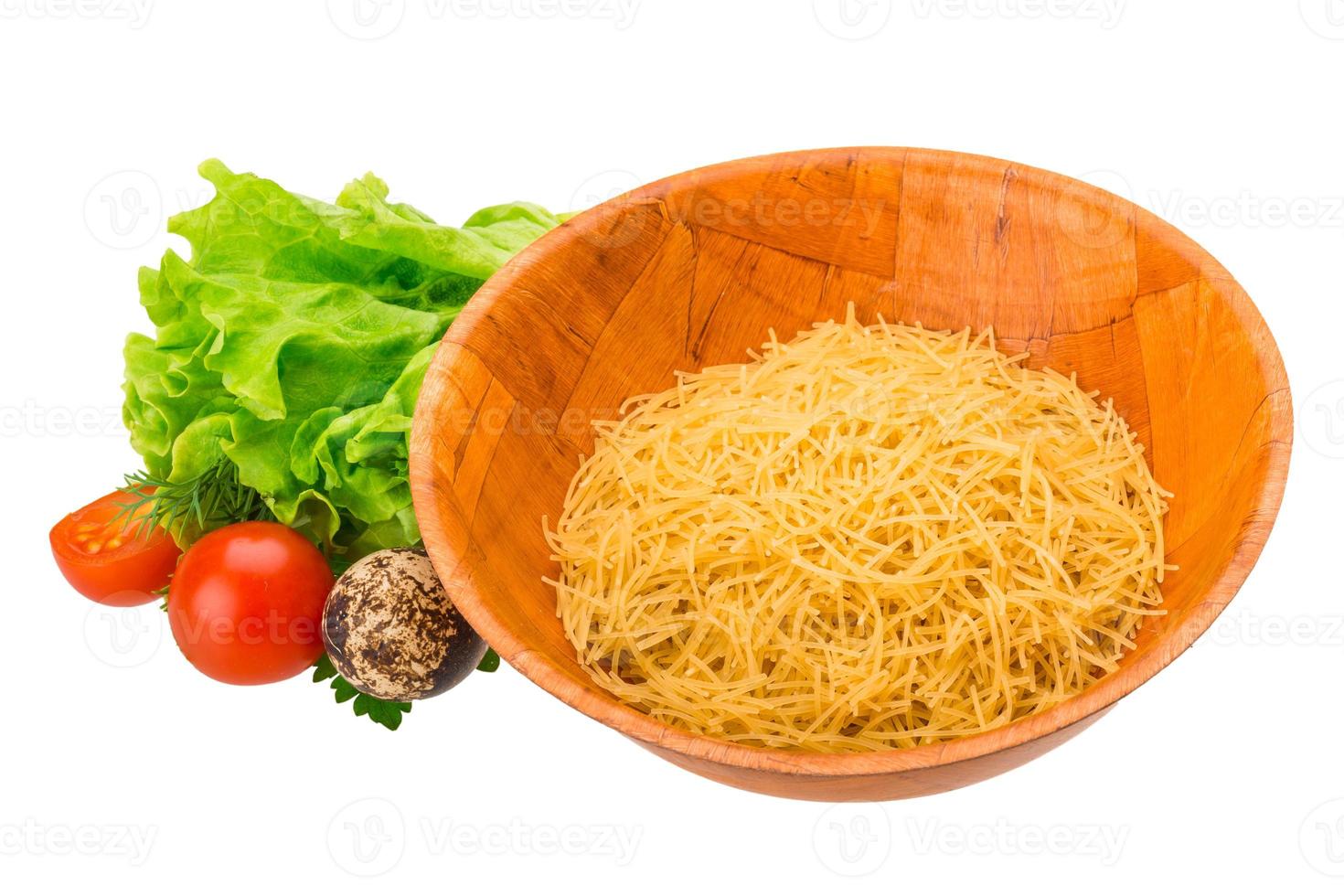 Raw pasta in a bowl on white background photo