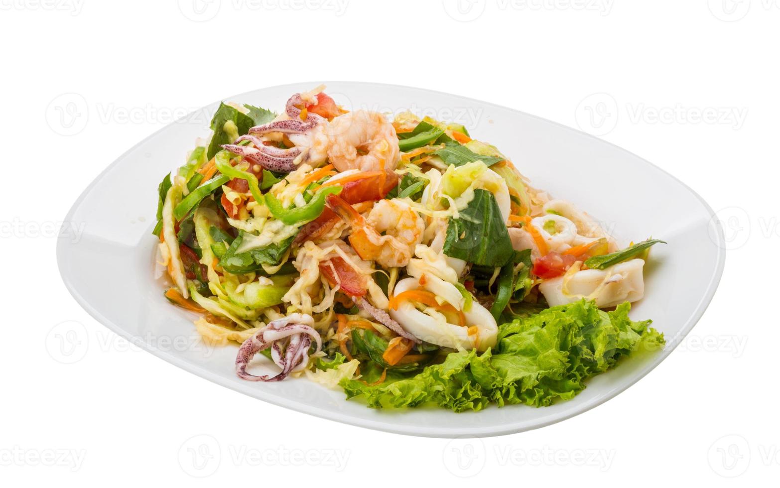 Asian seafood salad on the plate and white background photo