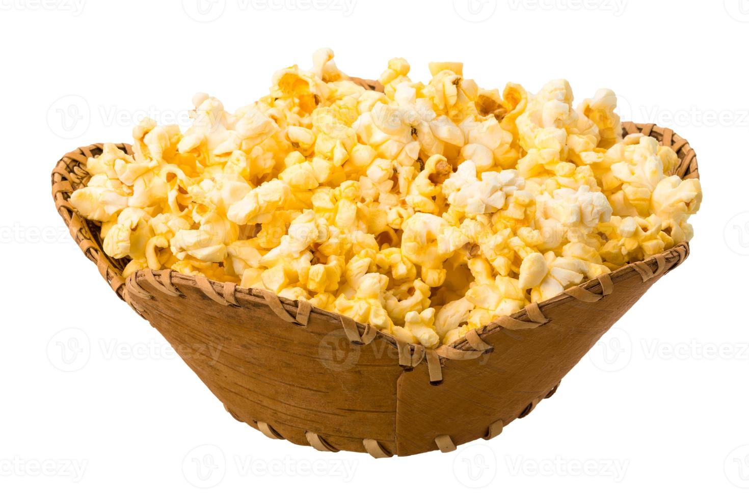 Popcorn in a basket on white background photo