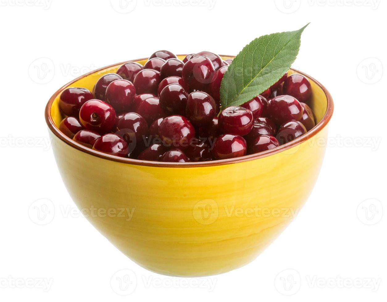 Cherry in a bowl on white background photo