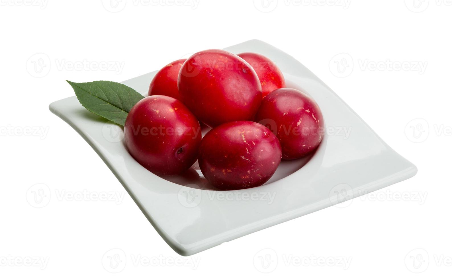Damson plum in a bowl on white background photo