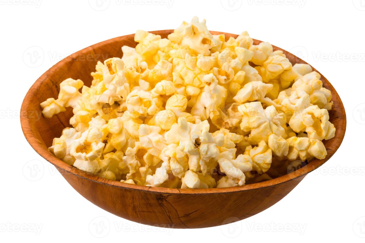 Popcorn in a bowl on white background photo