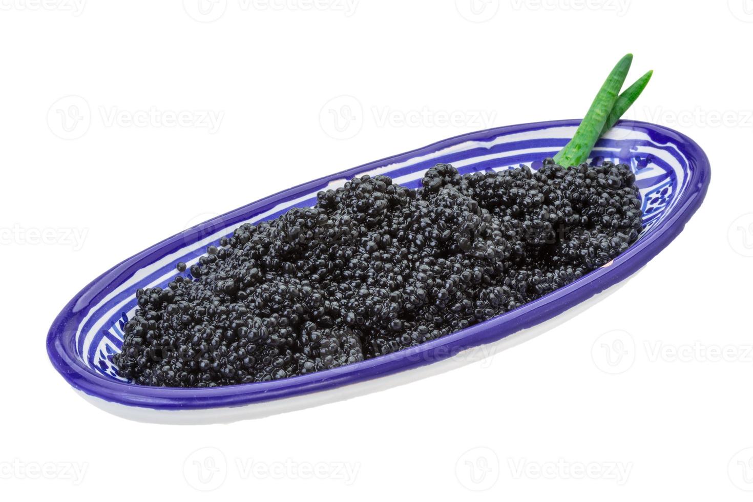 Black caviar in a bowl on white background photo