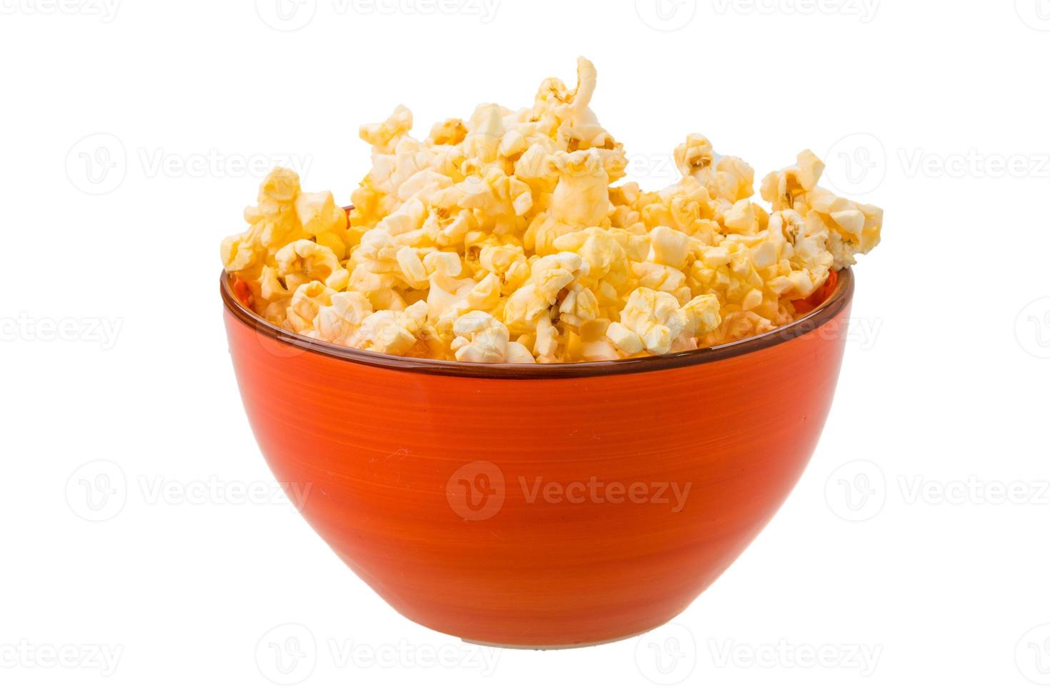 Popcorn in a bowl on white background photo