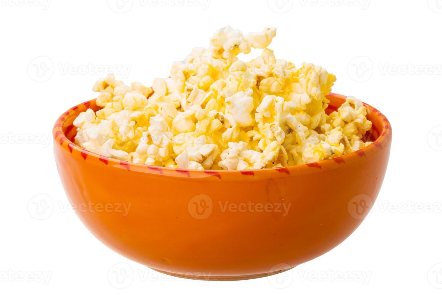 Popcorn in a bowl on white background photo