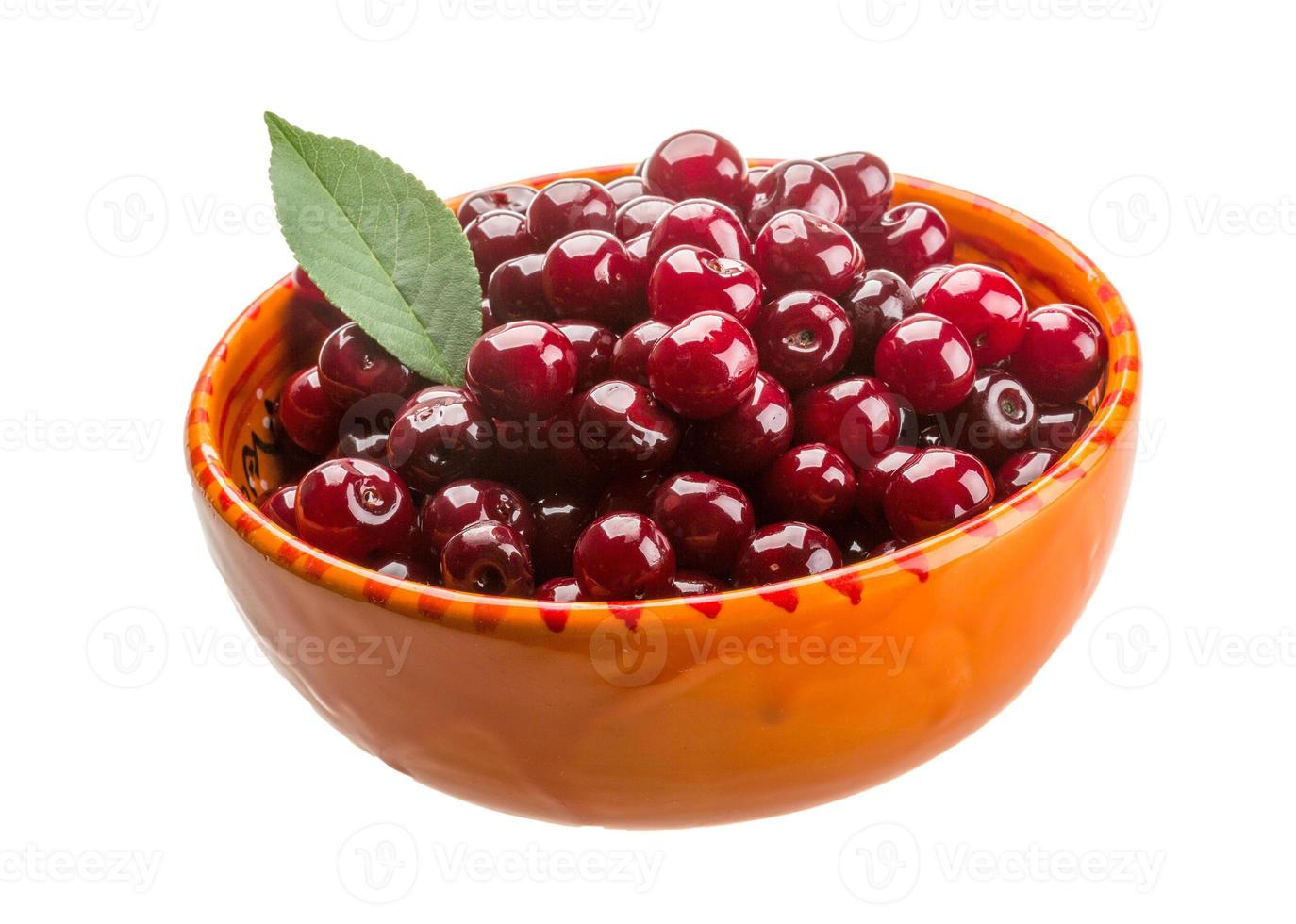 Cherry in the bowl on white background photo