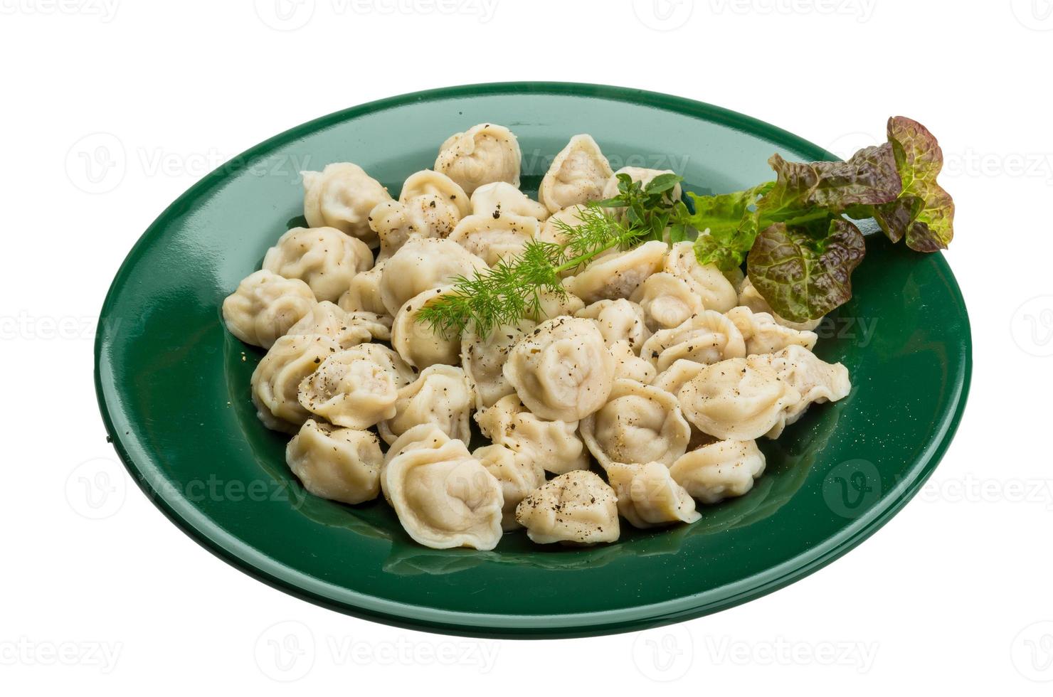 Russian dumplings on the plate and white background photo