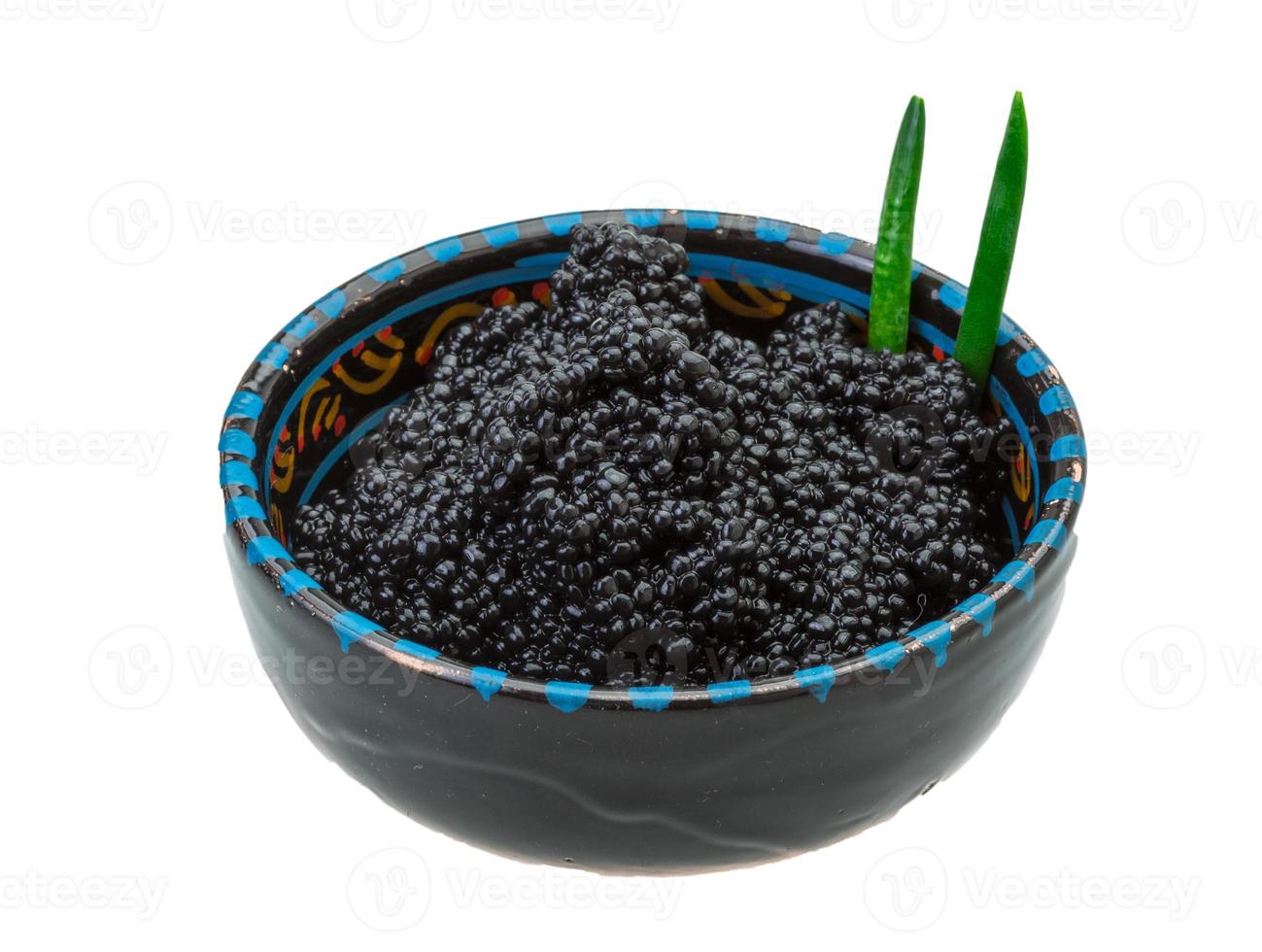 Black caviar in a bowl on white background photo