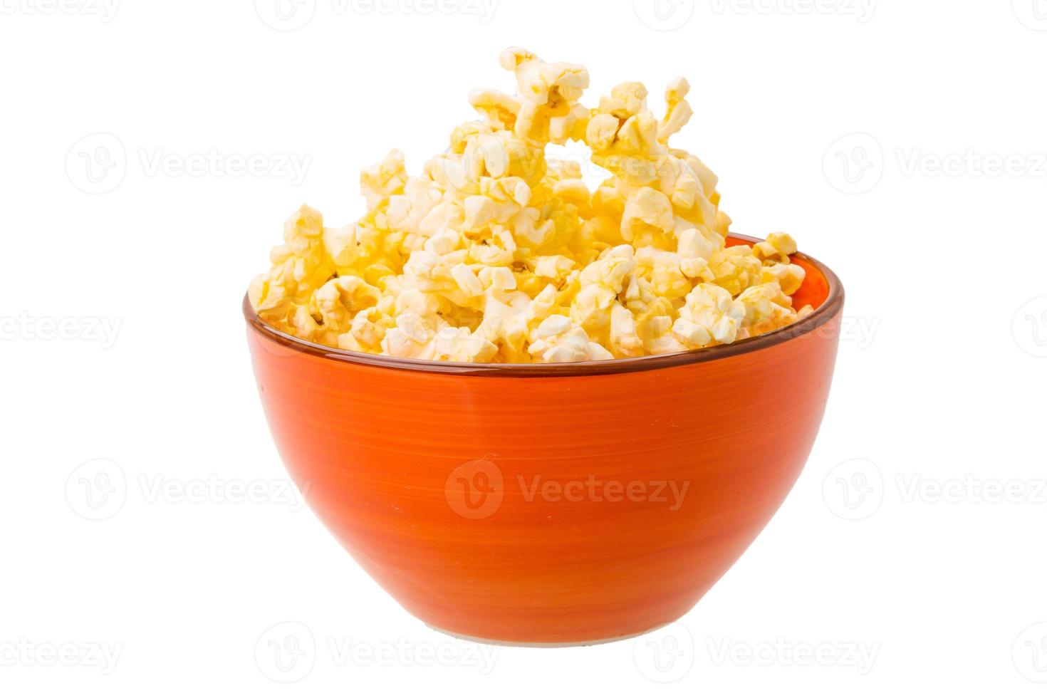 Popcorn in a bowl on white background photo