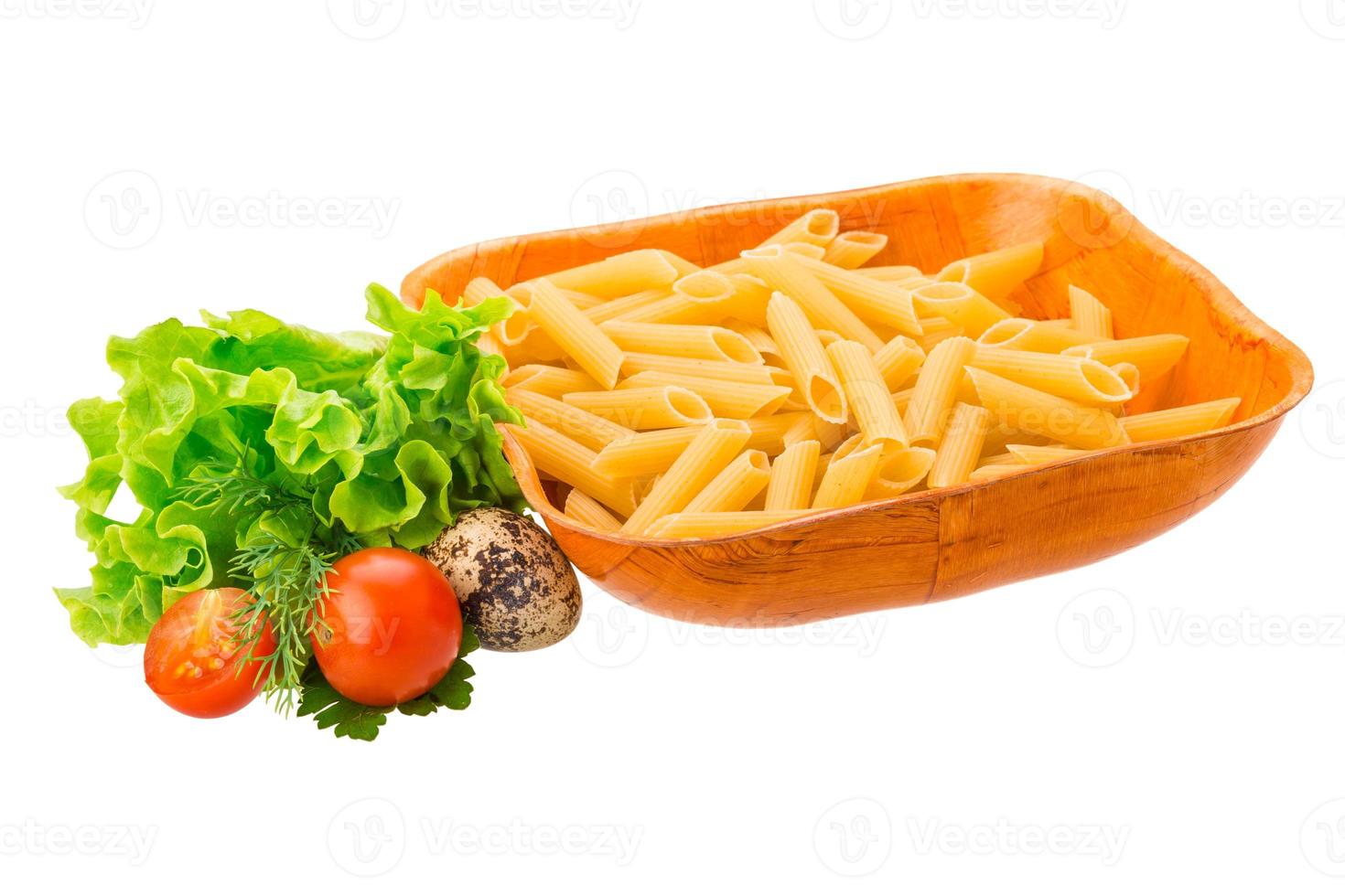 Raw pasta in a bowl on white background photo