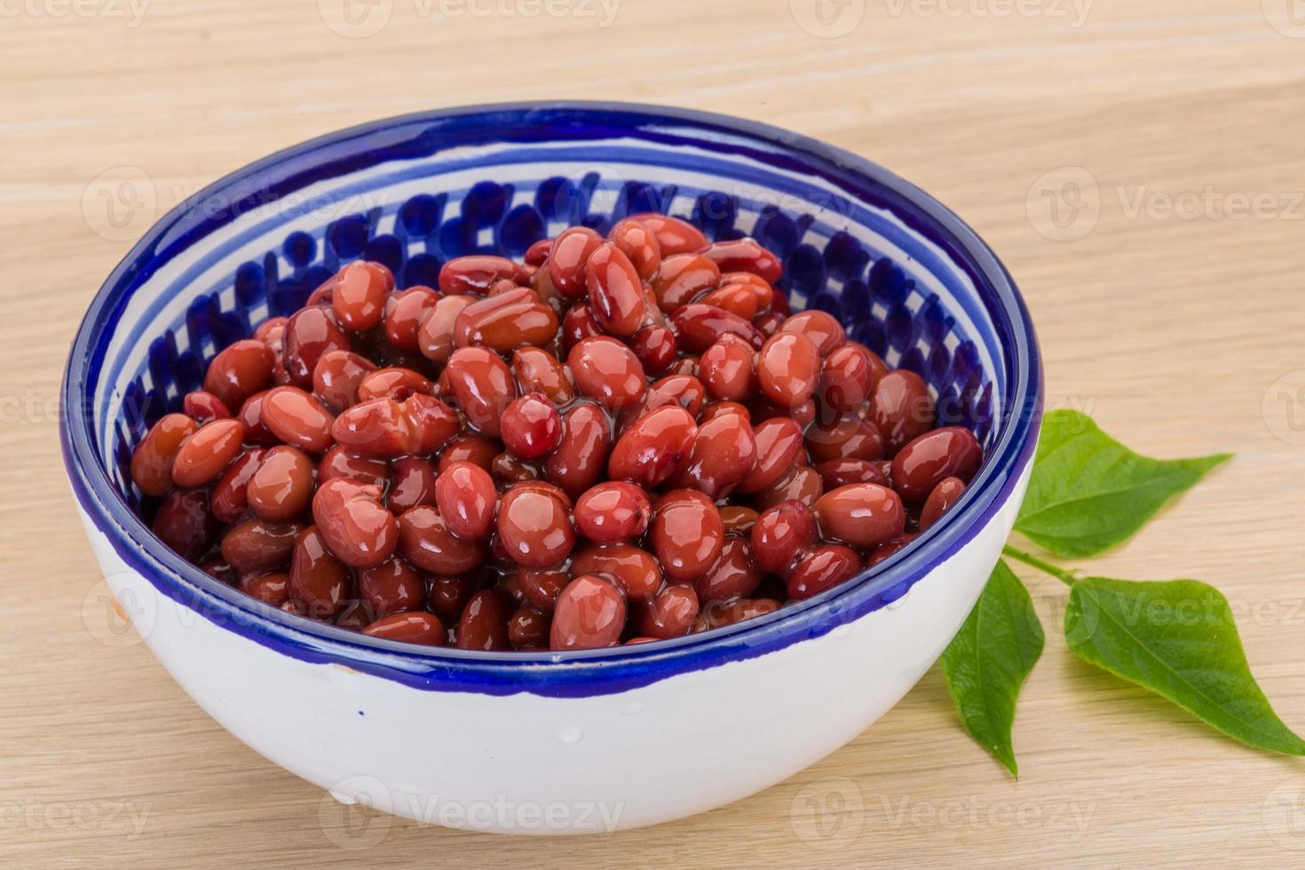 Red beans in a bowl on wooden background photo