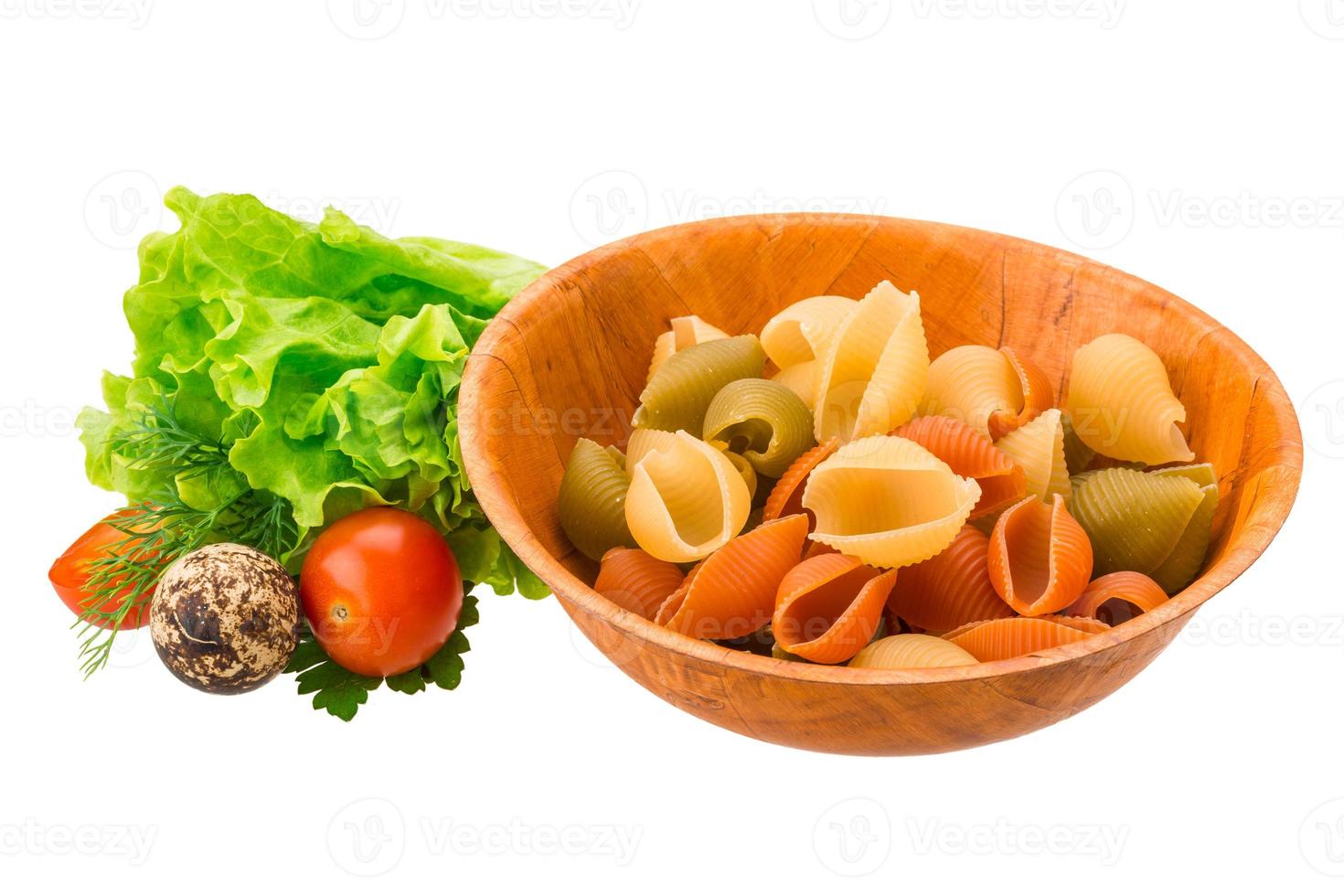 Raw pasta in a bowl on white background photo